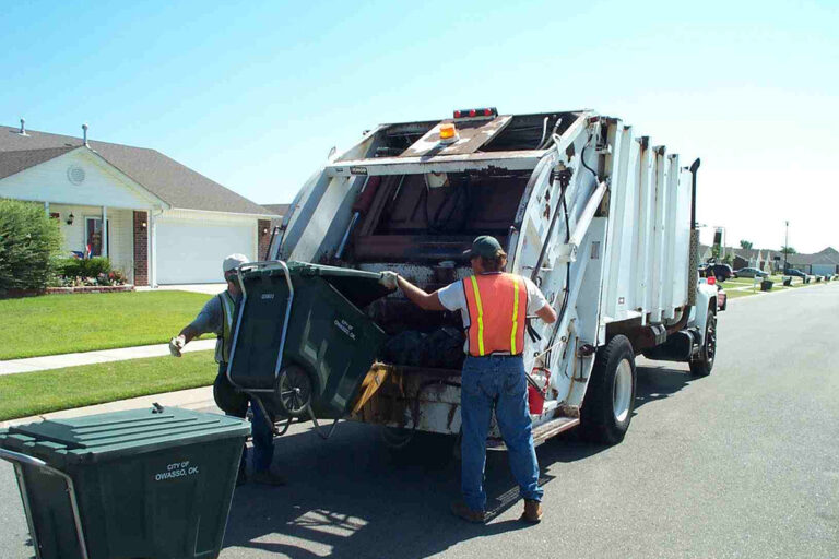 Garbage truck collecting residential waste bins in a neighborhood for Garbage Removal Services Kent WA