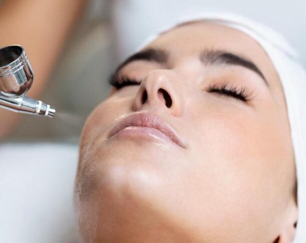 Close-up of a client enjoying an Oxygen Facial Vienna, VA treatment with an airbrush oxygen device for glowing, hydrated skin.