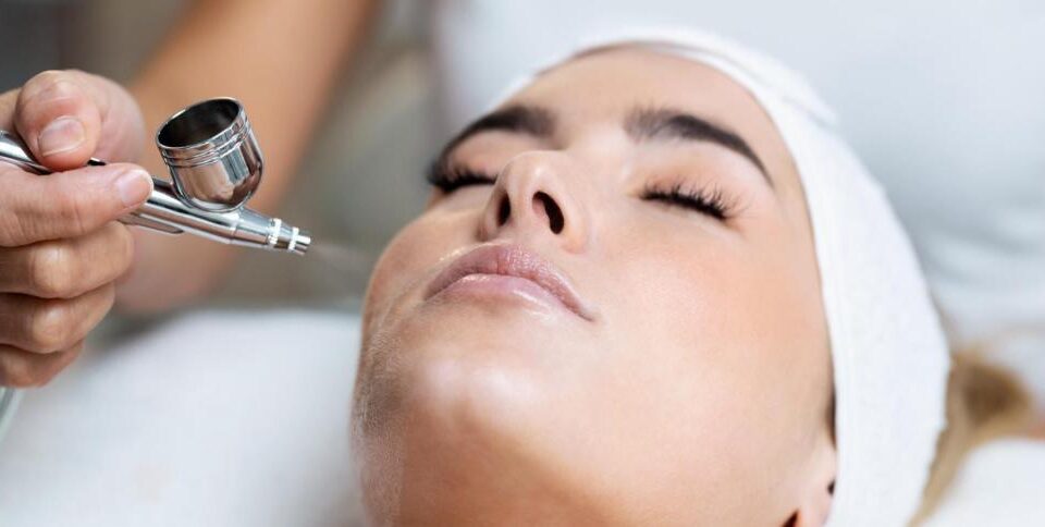 Close-up of a client enjoying an Oxygen Facial Vienna, VA treatment with an airbrush oxygen device for glowing, hydrated skin.